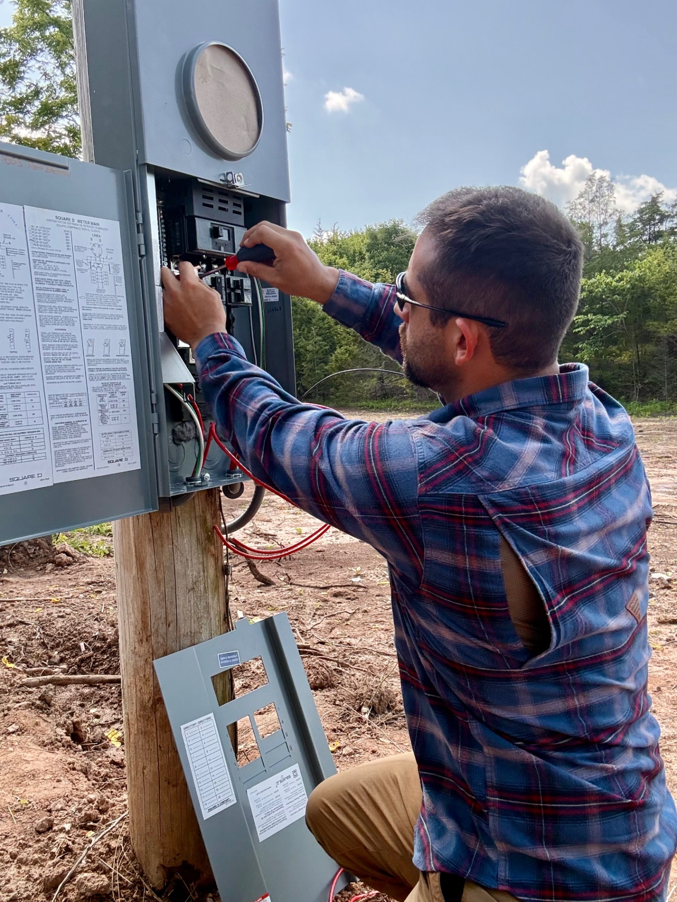 Ryan Trent wiring a Square D meter main on a service pole in Hawkins County TN