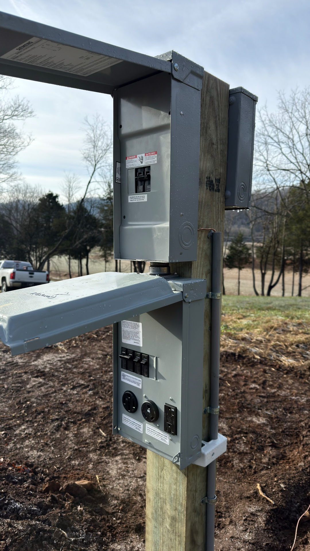 Pole-mounted temporary service with meter, breakers, and receptacle on a rural Hawkins County TN property