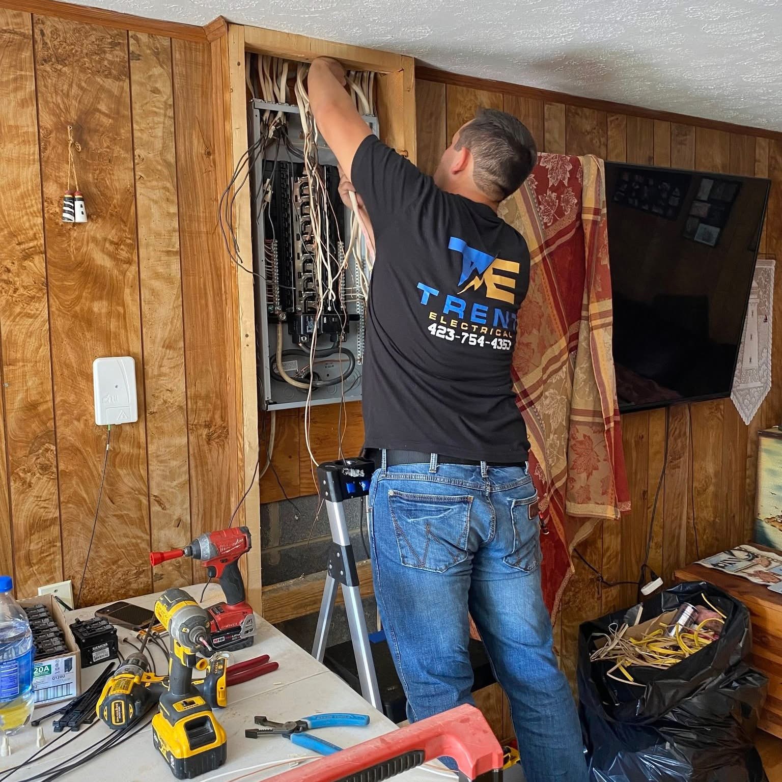 Licensed Rogersville TN electrician troubleshooting an electrical panel with a multimeter